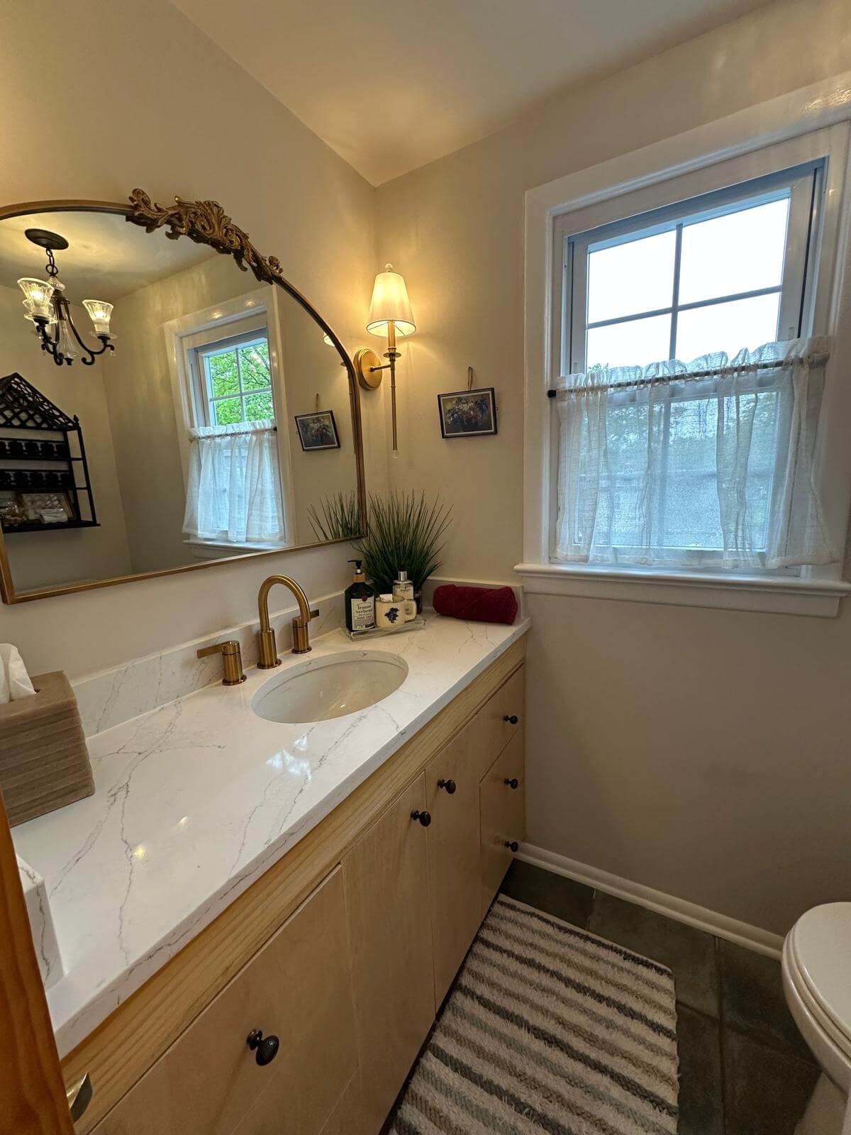Marble vanity & gold fixtures · spotless