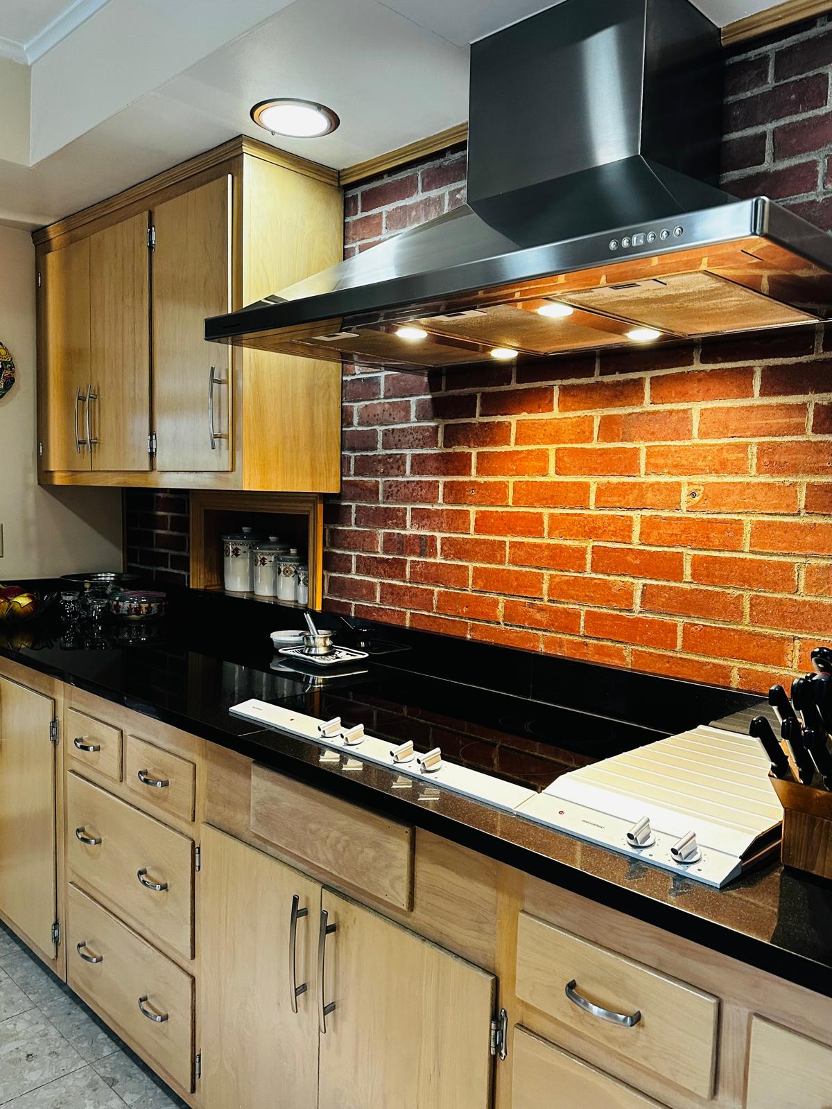 Brick backsplash & granite counters · polished